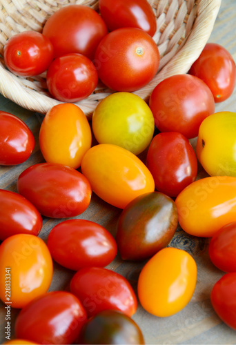 Canvas Print Tomato Varieties ,Type and color mixed together in basket on wooden floor
