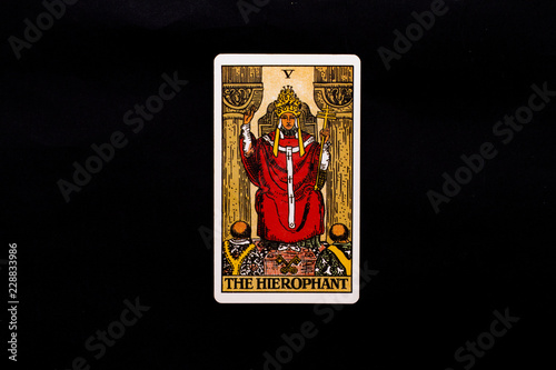 An individual major arcana tarot card isolated on black background. The Hierophant.
