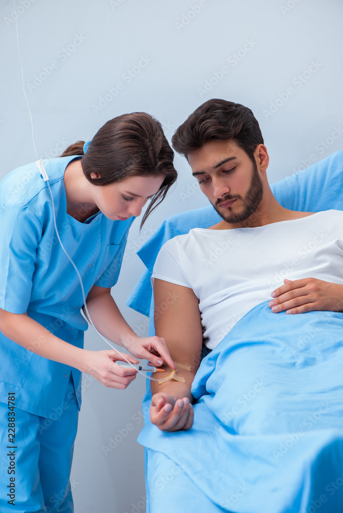 Woman doctor examining male patient in hospital Woman doctor examining male patient in hospital