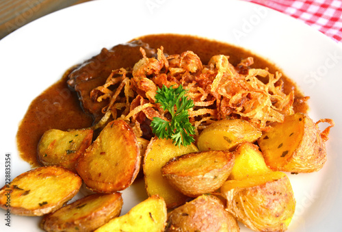 onion-topped roast beef with gravy is the favorite dish in Austria. (German name is Zwiebelrostbraten)
Beef,potatoes and onion menu in European style.