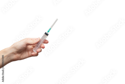 Femal hand holding syringe . Medical and science Concept. White background, isolated, close up