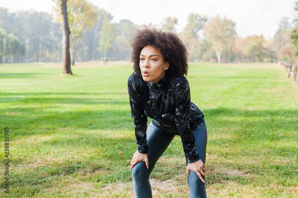 Sporty Girl Relaxing After Running On Green Fields