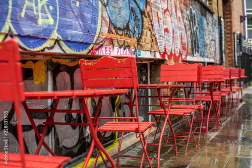 Colorful red chairs in the streets of London under a light rain - 3 © gdefilip