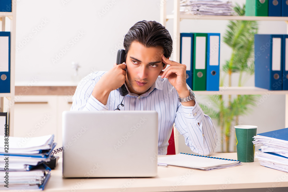 Young employee sitting at the office Young employee sitting at the office