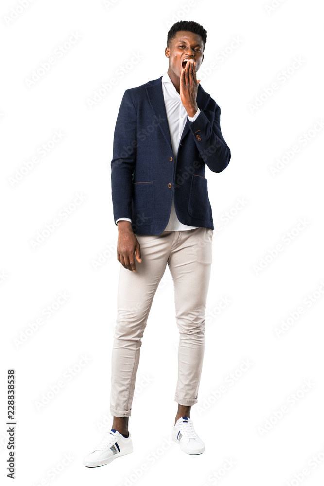 Full body of Handsome african american man wearing a jacket yawning and covering wide open mouth with hand. Sleepy expression on white background Full body of Handsome african american man wearing a jacket yawning and covering wide open mouth with hand. Sleepy expression on white background