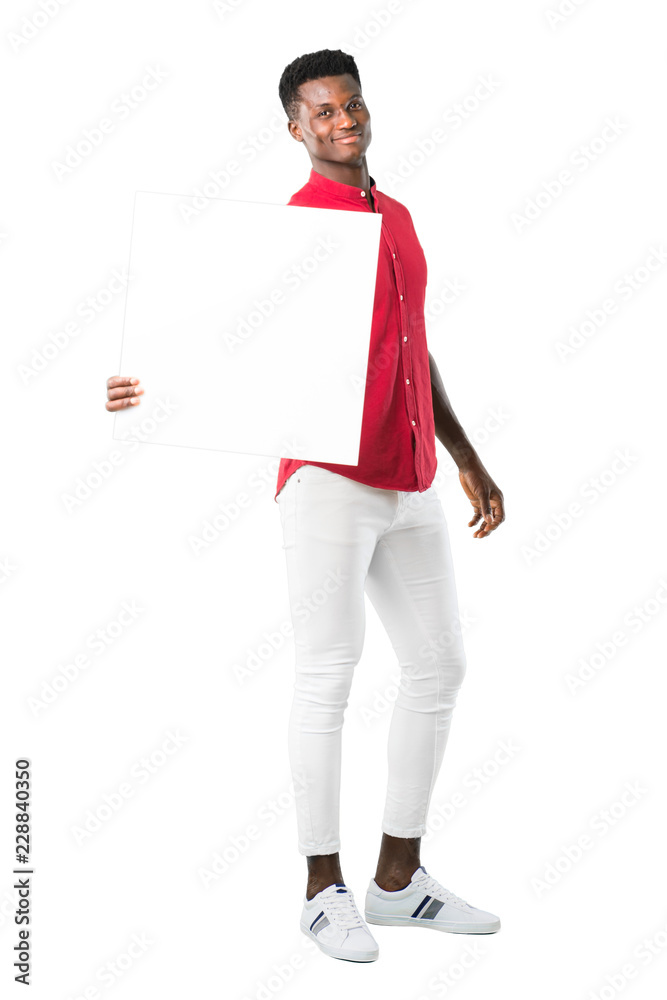 Full body of Young african american man holding an empty white placard for insert a concept on white background Full body of Young african american man holding an empty white placard for insert a concept on white background