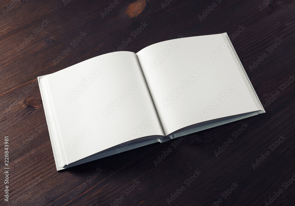 Fototapeta premium Mockup of open book on wood table background. Responsive design template.