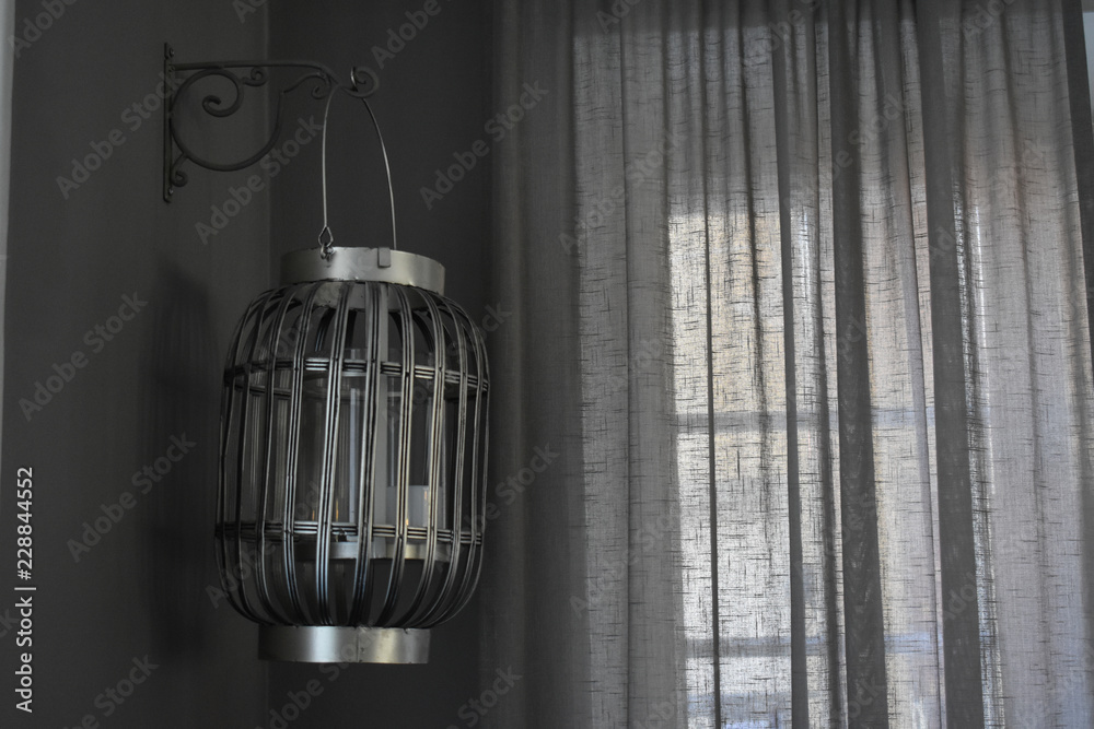 Gray lamp, cream curtain and dim room. Everything appeared gray. Gray lamp, cream curtain and dim room. Everything appeared gray.