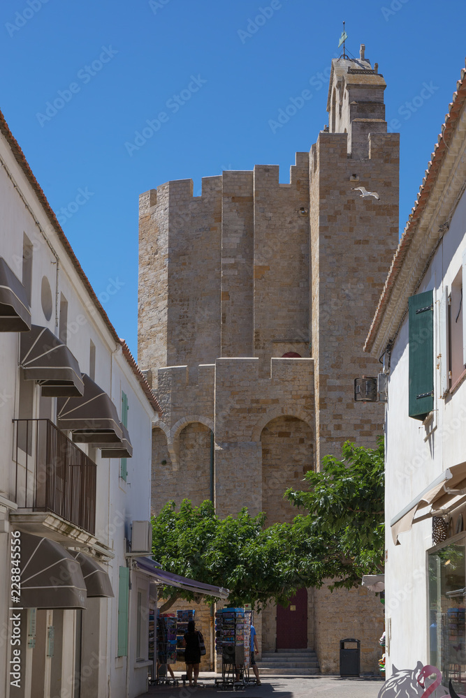 .On the streets of the maritime French city of Saintes-Maries-de-la-Mer. Fragment of the church Notre-Dame-de-la-Mer