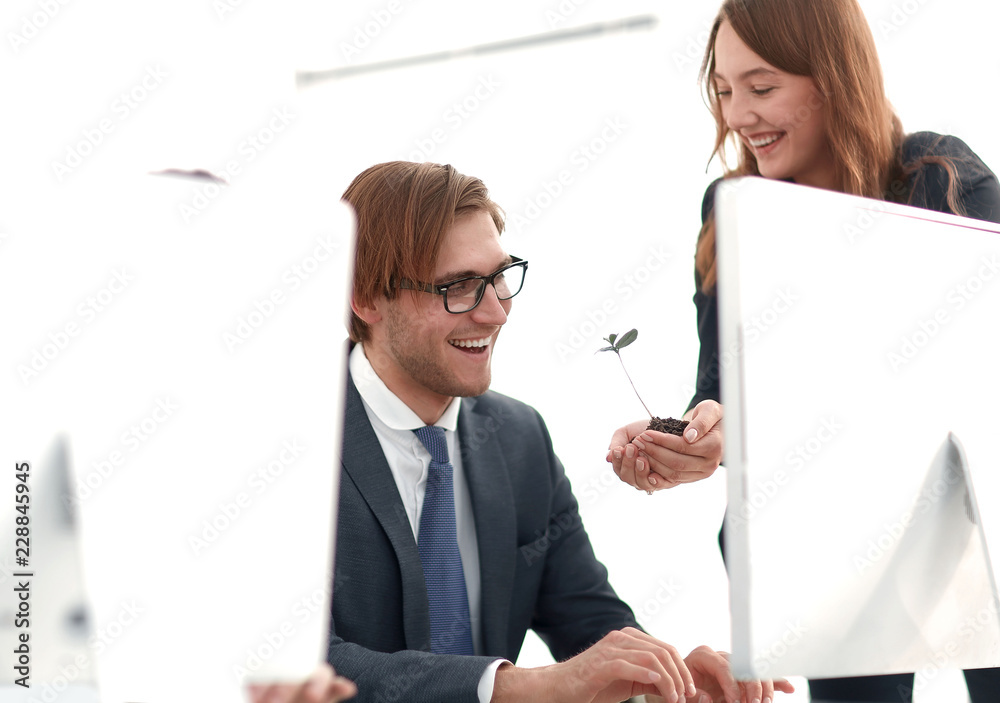 business woman shows the team a green sprout business woman shows the team a green sprout