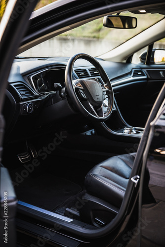 Luxurious car interior view through the open drivers door © aleluk