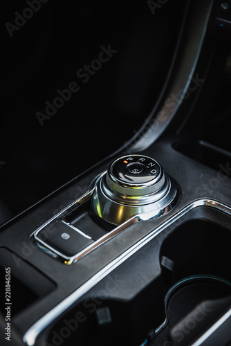 Rotary gear shift with parking brake button