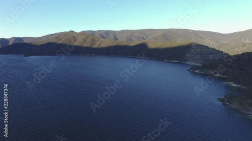 Aerial pan across Talbingo reservoir at sunset. NSW, Australia