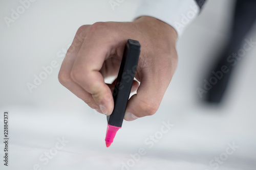 close up.businessman draws a marker on the flipchart.