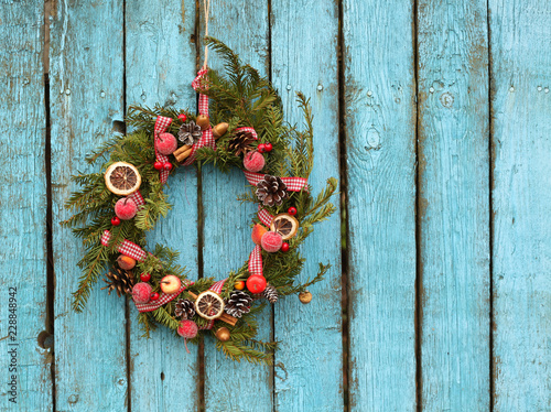 Christmas wreath on the rustic wooden background