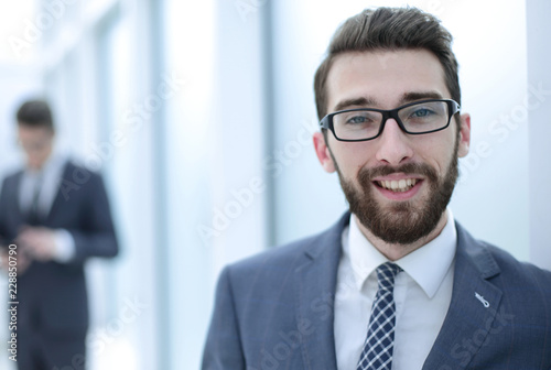 close up.businessman with glasses on the background of the offic