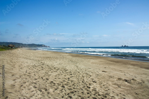 Long and empty sand beach on the pacific ocean  Ecuador.