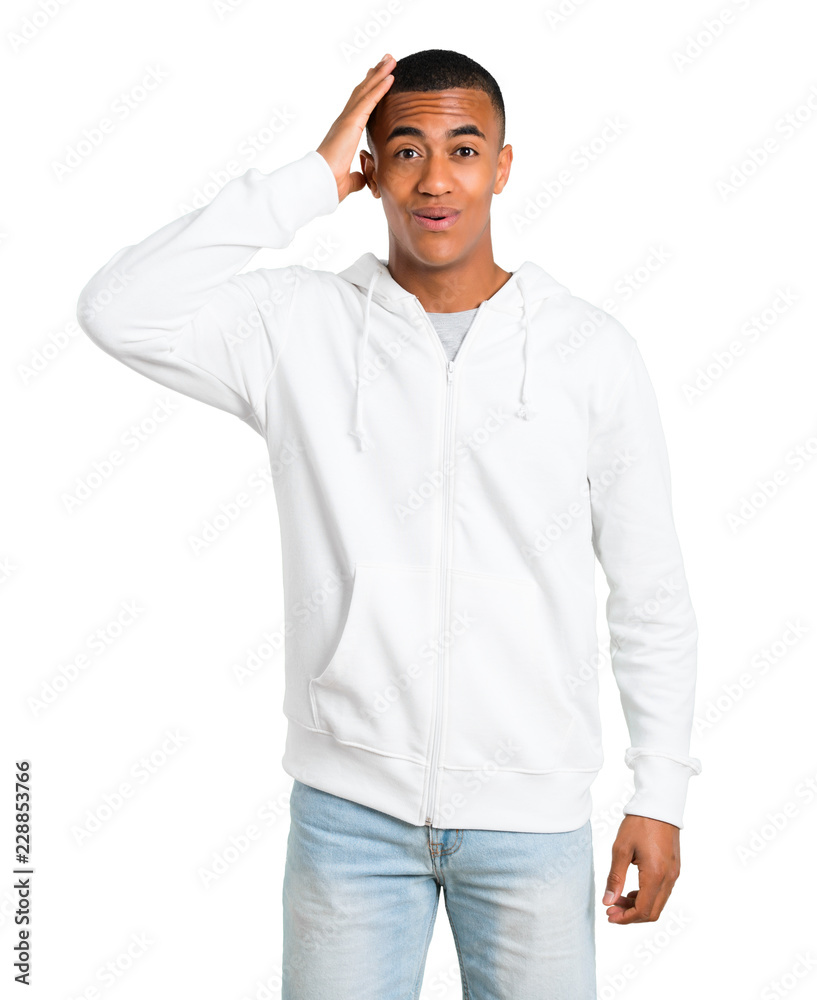 Dark-skinned young man with white sweatshirt has just realized something and has intending the solution on isolated white background Dark-skinned young man with white sweatshirt has just realized something and has intending the solution on isolated white background
