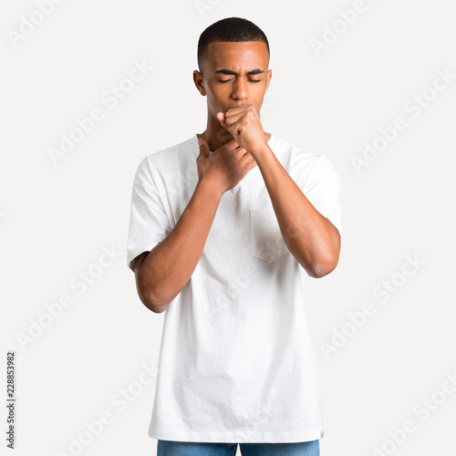 Young african american man is suffering with cough and feeling bad on isolated background © luismolinero