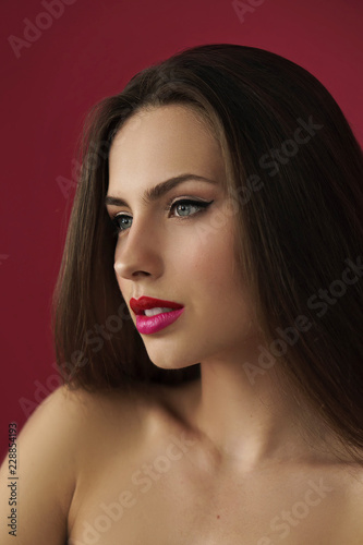 image of brunette woman on red background