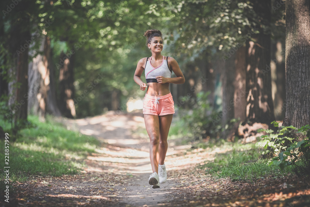 Full length shot of a beautiful young woman running outdoor in the morning Full length shot of a beautiful young woman running outdoor in the morning