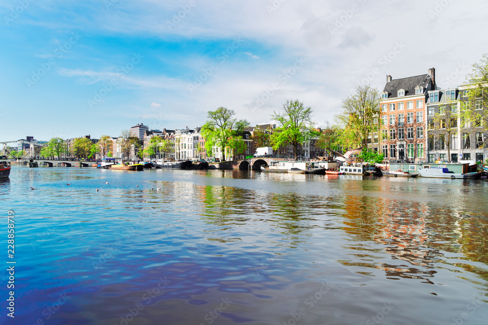 Naklejka premium embankment of Amstel canal in Amsterdam, Netherlands