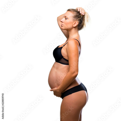 Blonde pregnant woman in underwear on isolated white background