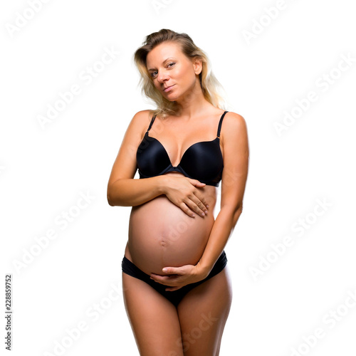 Blonde pregnant woman in underwear on isolated white background © luismolinero