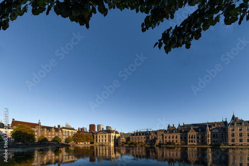 Reflection of the Buitenhof, Binnenhof buildings, Dutch parliament campus under a clear blue sky in The Hague, Netherlands photo