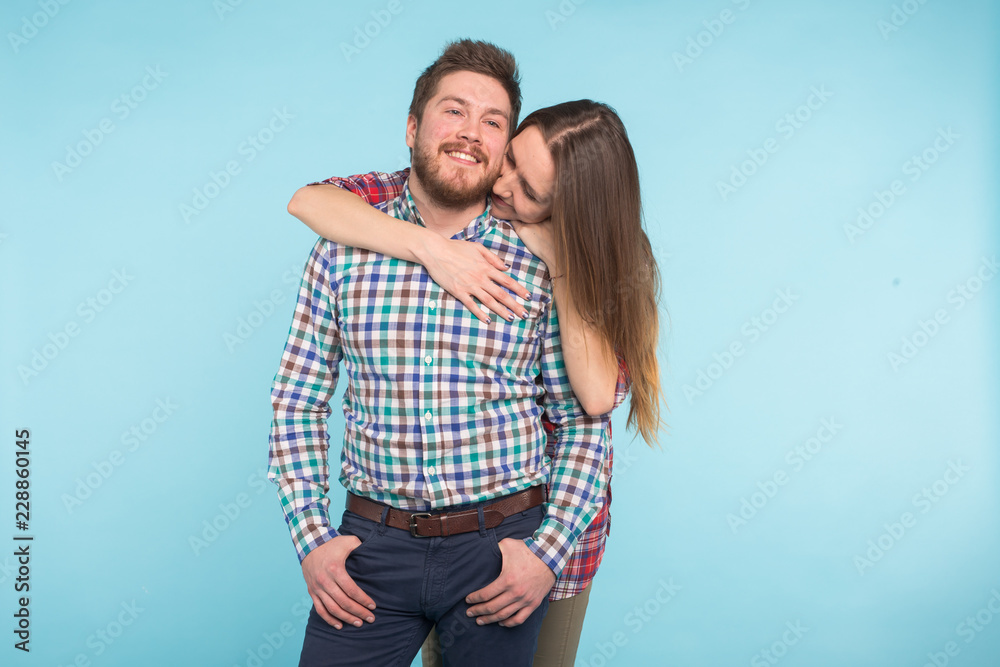 Portrait of cheerful funny young lovers on blue background Portrait of cheerful funny young lovers on blue background