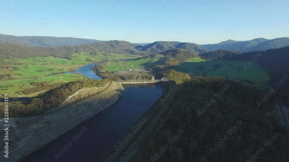 Backward flight along beautiful river and mountains at sunset Backward flight along beautiful river and mountains at sunset