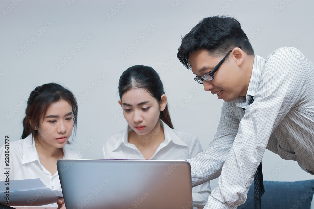 Teamwork and brainstorm concept. Group of Asian business people working with laptop together in modern office. Teamwork and brainstorm concept. Group of Asian business people working with laptop together in modern office.