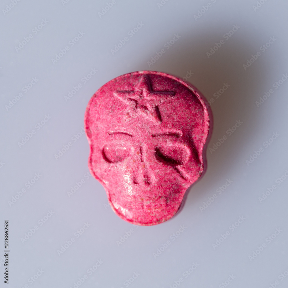 A Red Army Skull, Ecstasy, XTC pill on a grey background. Photo | Adobe Stock