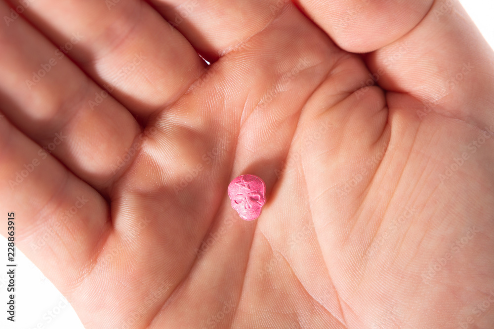 Red Army Skull, Ecstasy, pain killer or xtc pill in the palm of a caucasian  hand. Stock Photo | Adobe Stock