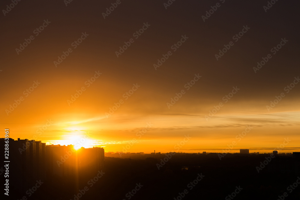 Orange sunset in the city. City landscape. Silhouette