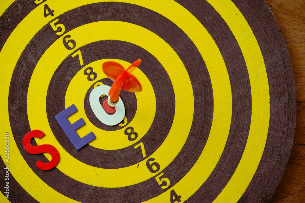 SEO Search Engine Optimization multi color logo alphabets ranking concept on dartboard background with red arrow hit center of target, SEO is one of online marketing business strategy to promote web SEO Search Engine Optimization multi color logo alphabets ranking concept on dartboard background with red arrow hit center of target, SEO is one of online marketing business strategy to promote web