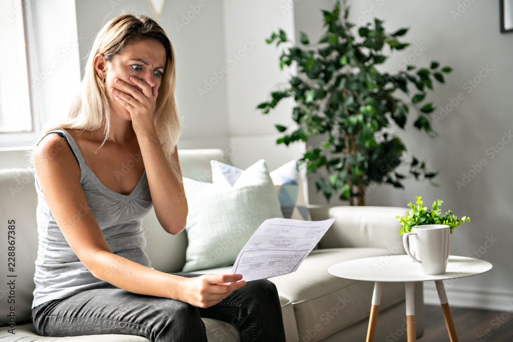 Blonde Beautiful woman stressed because of bills Blonde Beautiful woman stressed because of bills