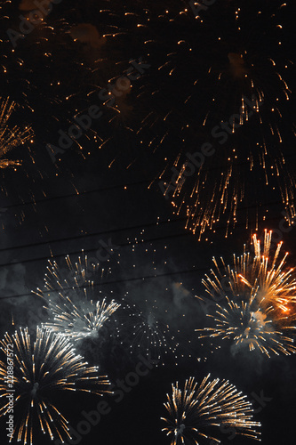 Texture of fireworks in the night sky. Bright lights in St. Petersburg. Red smoke and flashes