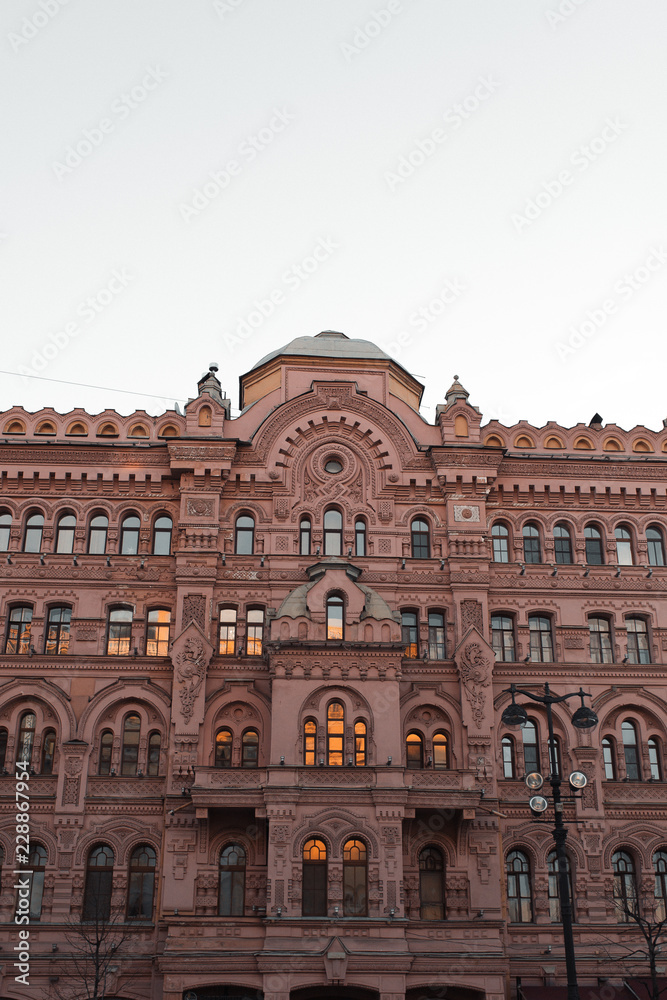 The formal architecture of St. Petersburg. The bridges and the river Neva embankment. Sunset over the city.