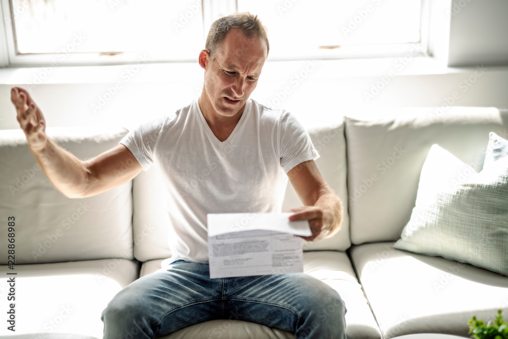 Bad news. Depressed mature man holding paper Bad news. Depressed mature man holding paper