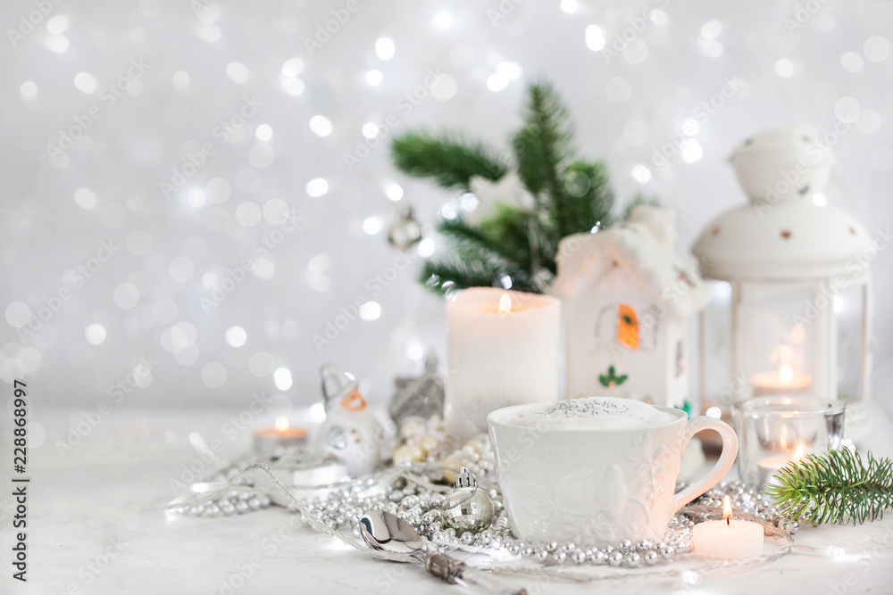 White cup of hot cappuccino coffee on holiday white and silver background, Christmas concept White cup of hot cappuccino coffee on holiday white and silver background, Christmas concept