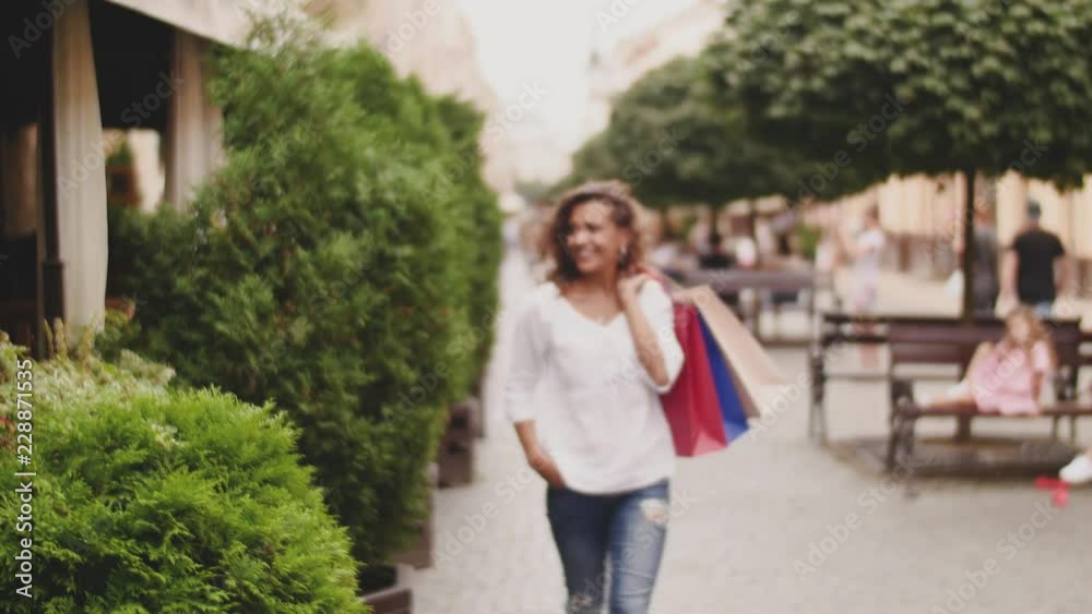 Girl crossing the street with shopping bags Girl crossing the street with shopping bags