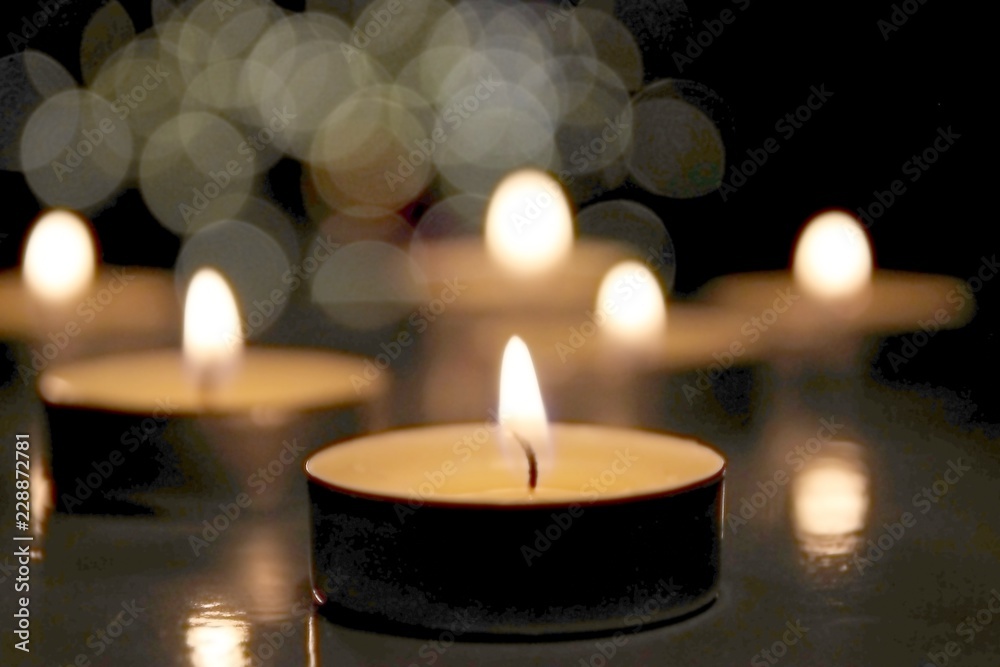 Flame of many candles burning on the bokehs background Flame of many candles burning on the bokehs background