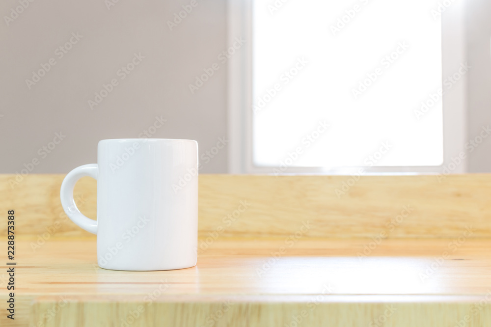 White coffee mug on wooden background in morning environment. Blank drink cup on product shelf for montage you design. White coffee mug on wooden background in morning environment. Blank drink cup on product shelf for montage you design.