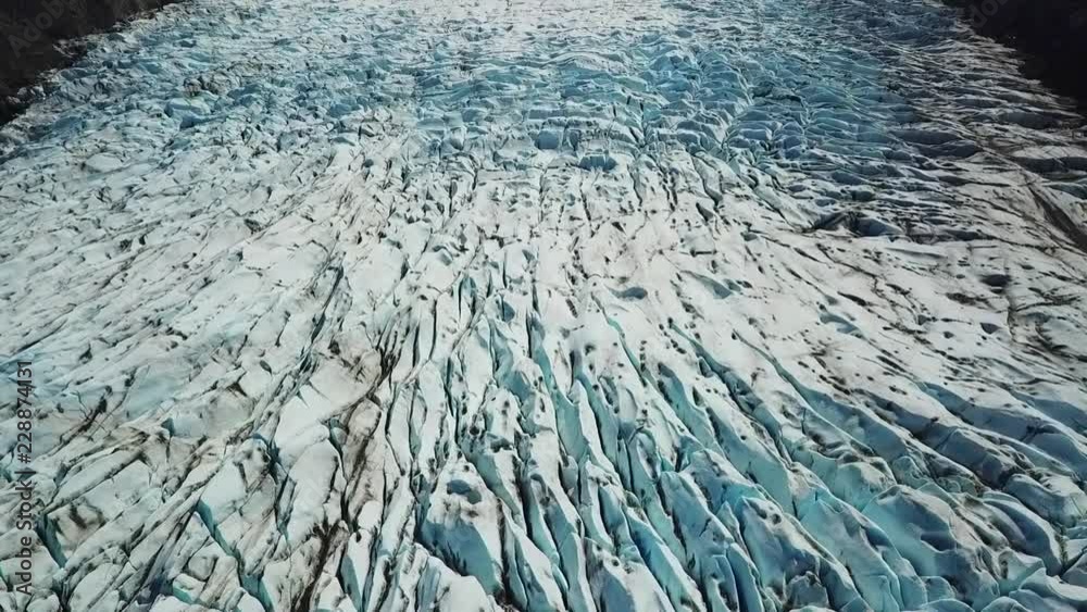 Aerial View Angling Down Blue Sky to Glacier Ice Aerial View Angling Down Blue Sky to Glacier Ice