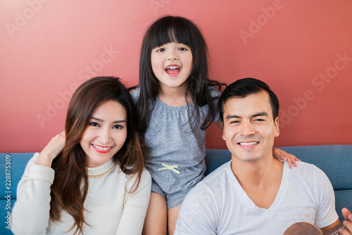 happiness family young female with parent play together with love and joyful on sofa in living room house relation concept