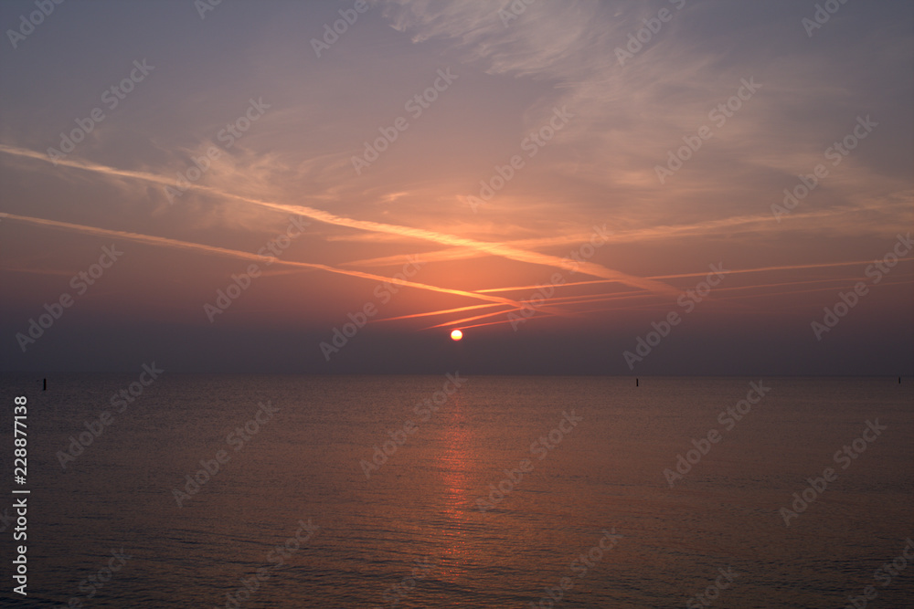 sunrise over the sea,jet trails,horizon,panorama,view,water,seaside,light,cloud,nature,beautiful