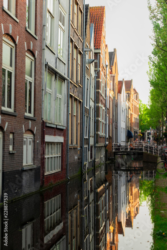 street with old houses over narrow canal in Delft old town in Holland © neirfy