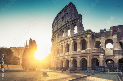 Colosseum in Rome, Italy, at sunrise. Colourful travel background.