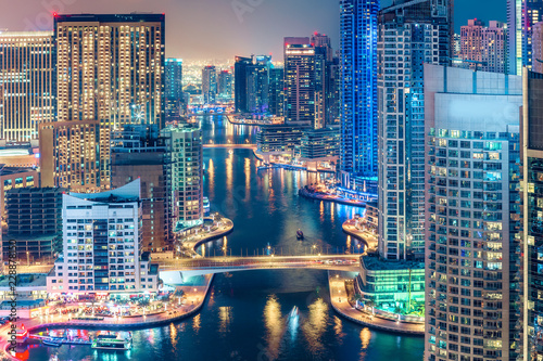 Scenic nighttime skyline of big modern city with illuminated skyscrapers. Aerial view of Dubai Marina, UAE.